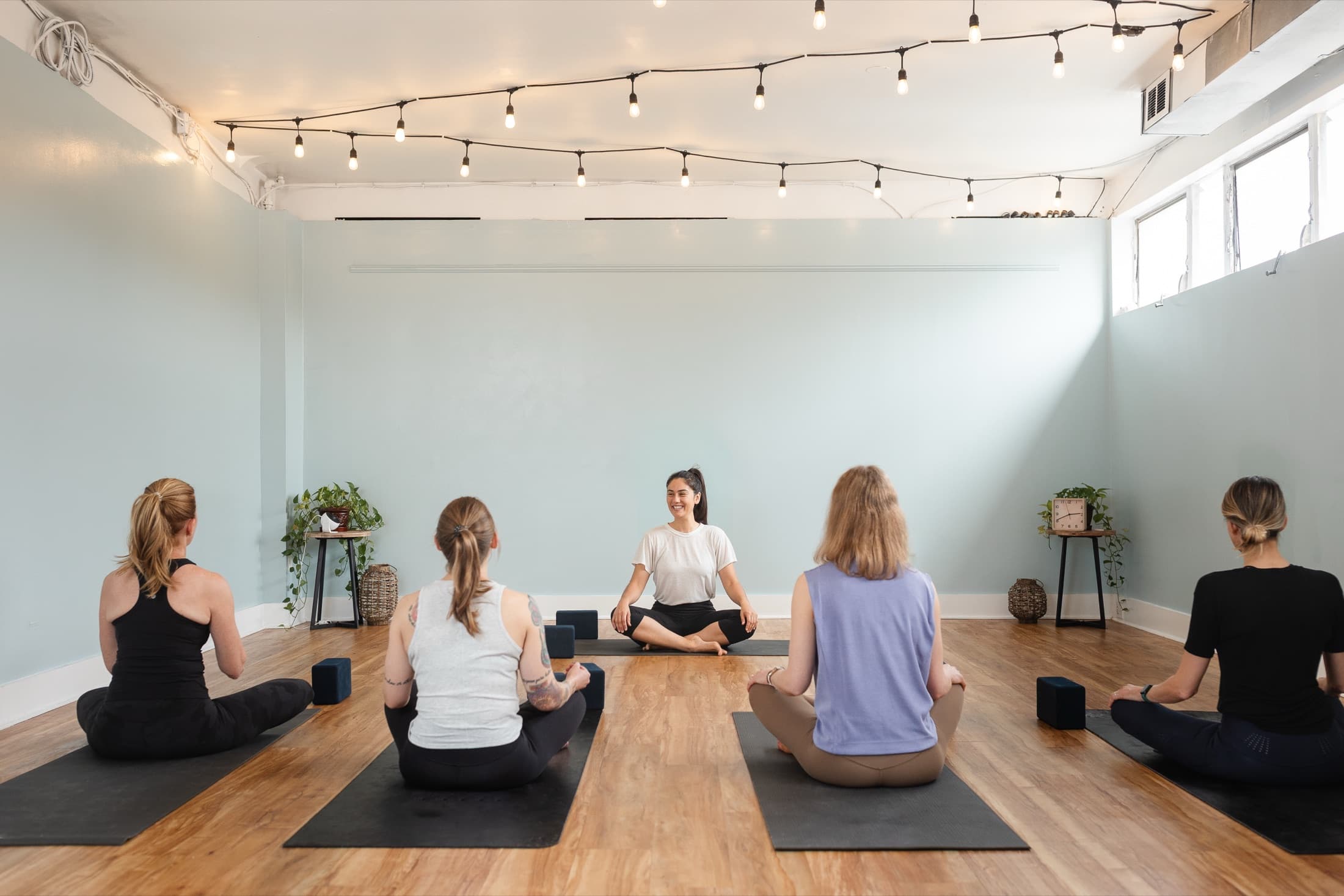 A Karma Yoga class gathered for practice in the studio.